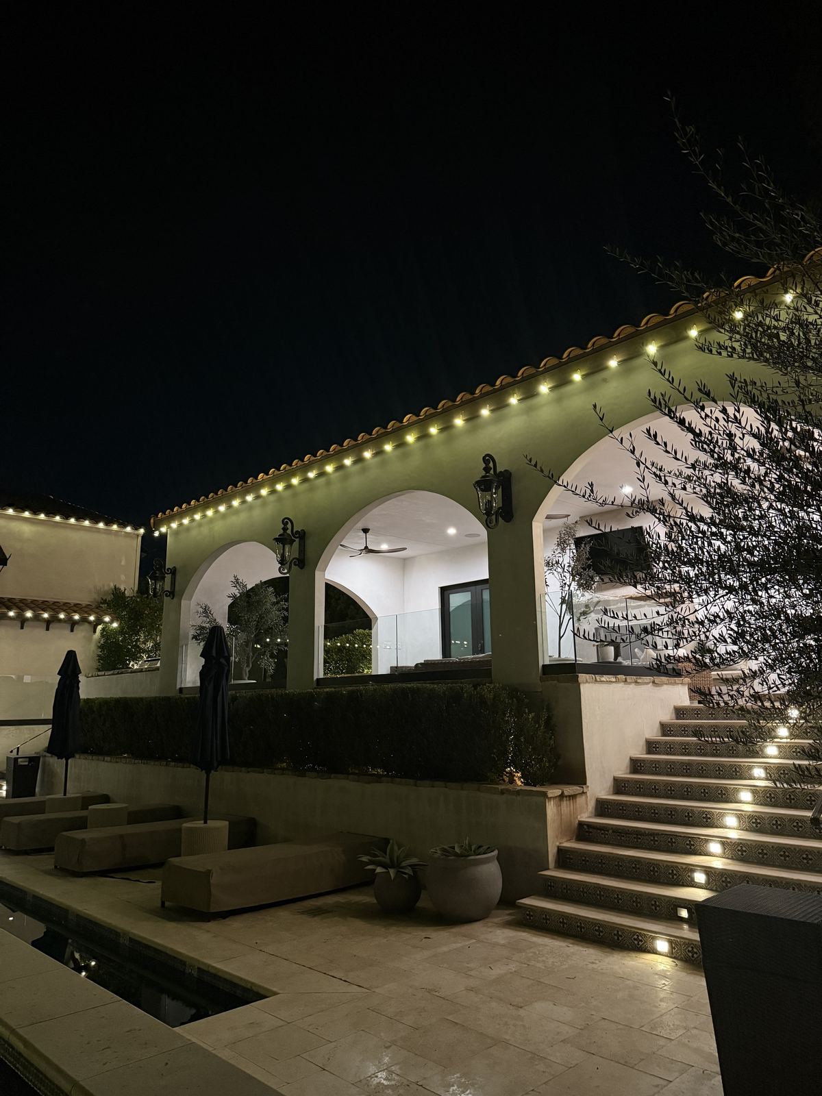 Mediterranean arches pool staircase — Christmas light installation in Riverside, CA