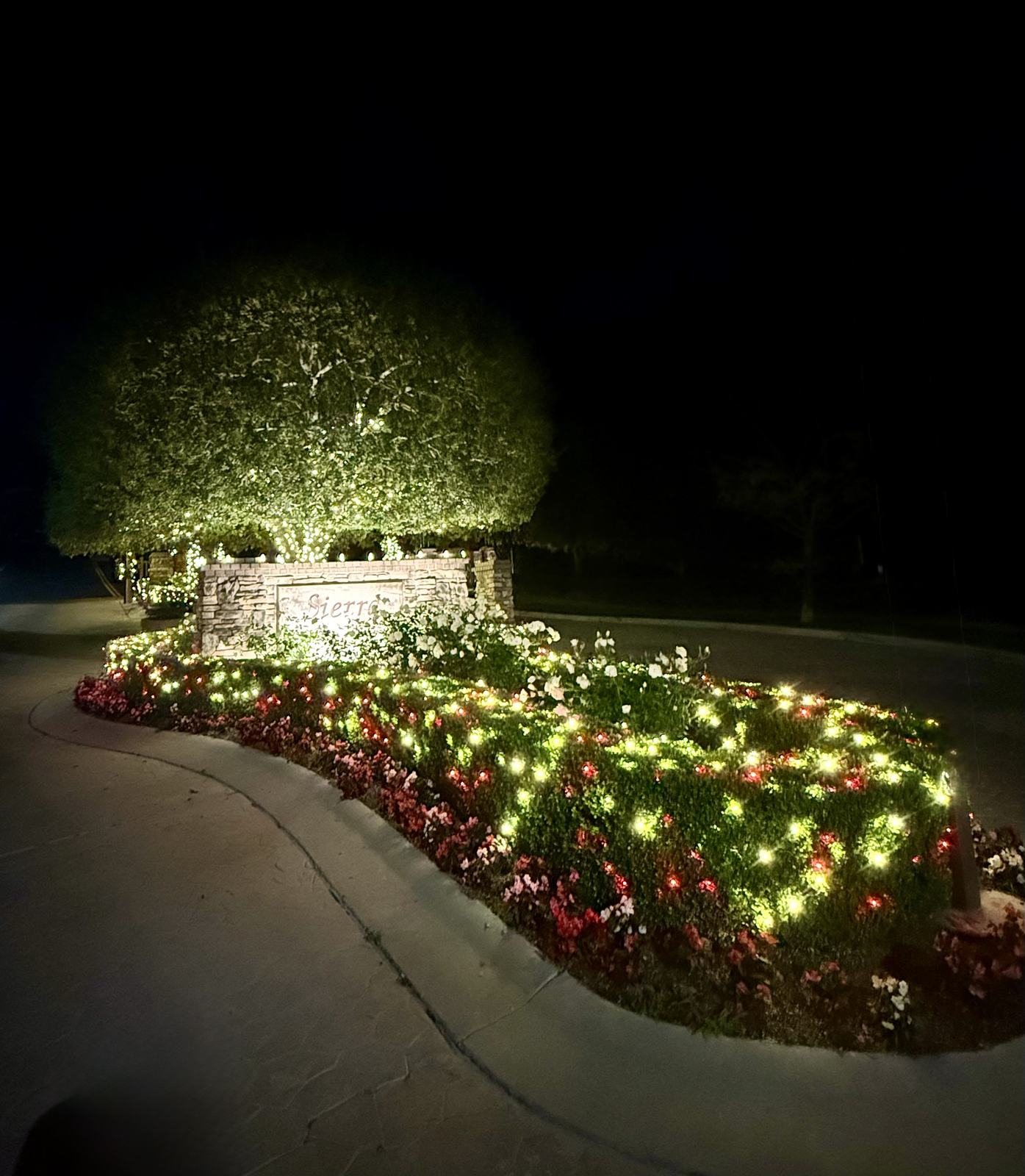 Sierra Peaks Community entrance sign lit up with Christmas lighting and landscape lighting in Corona, CA