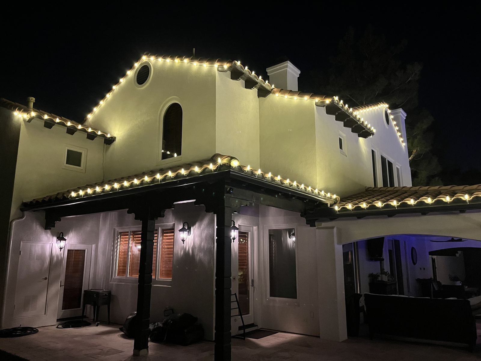 Spanish tile roofline Christmas lighting over patio