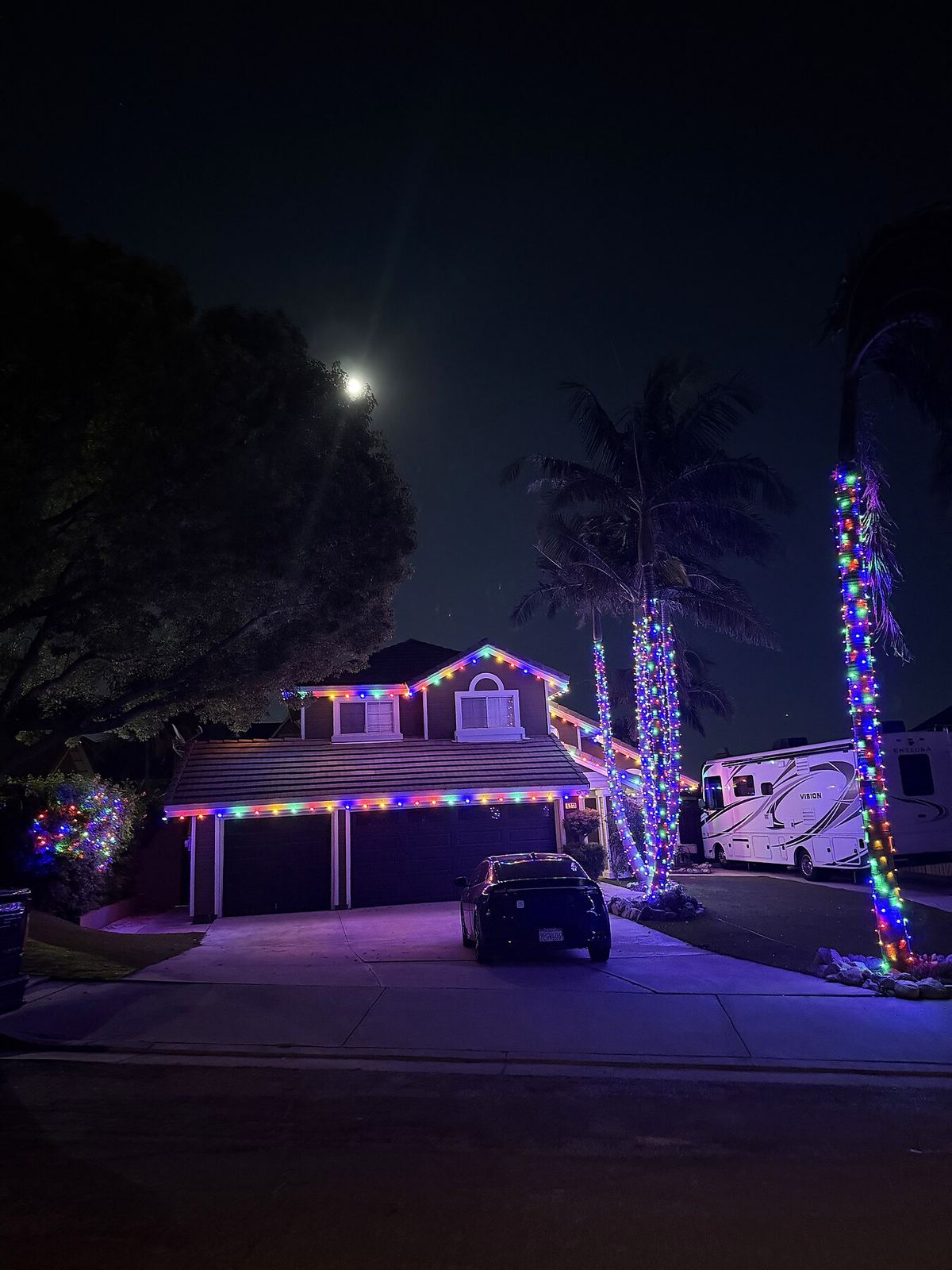 Two story rainbow palms rv night — Christmas light installation in Riverside, CA