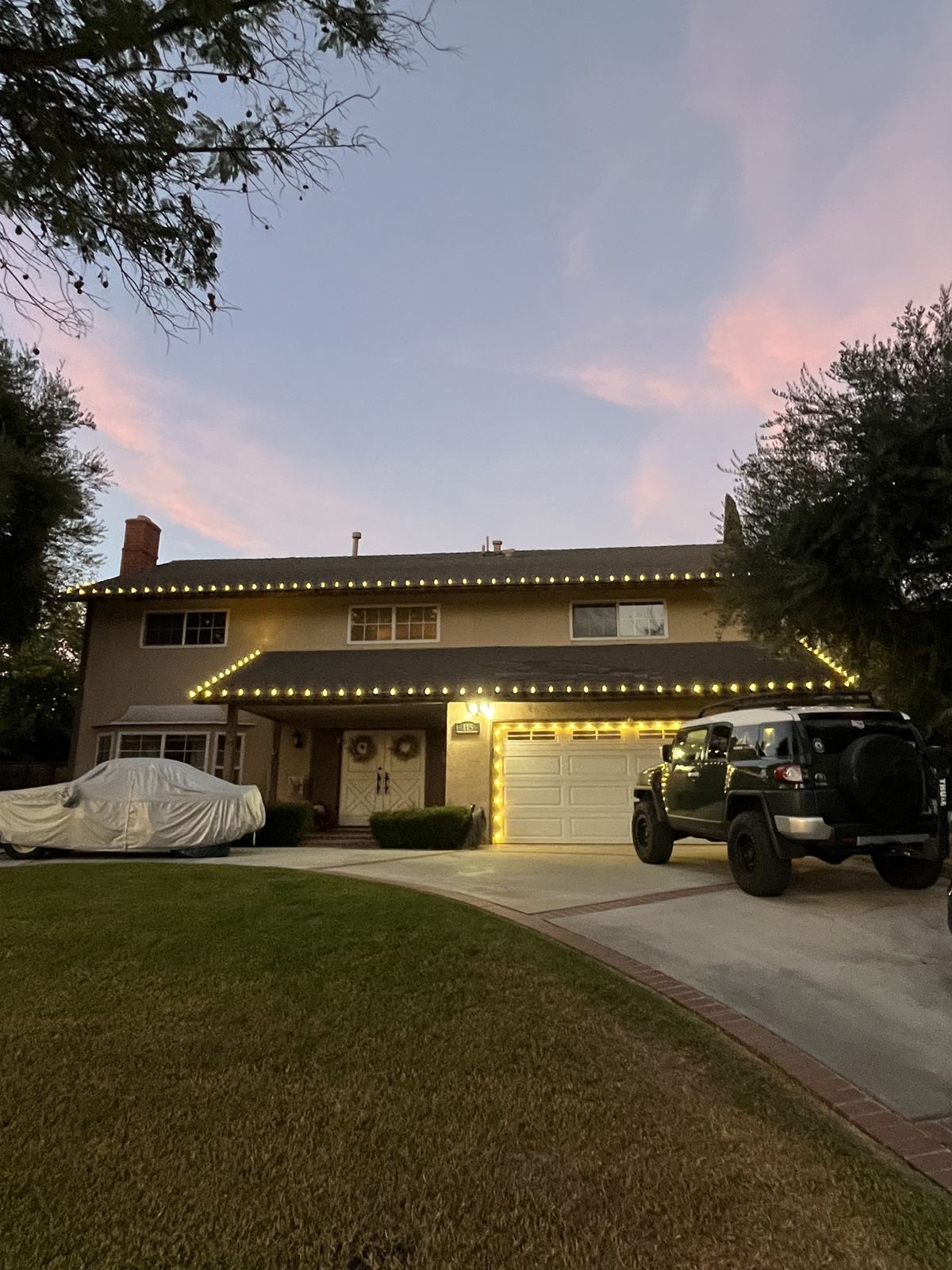 Two story roofline jeep sunset — Christmas light installation in Riverside, CA