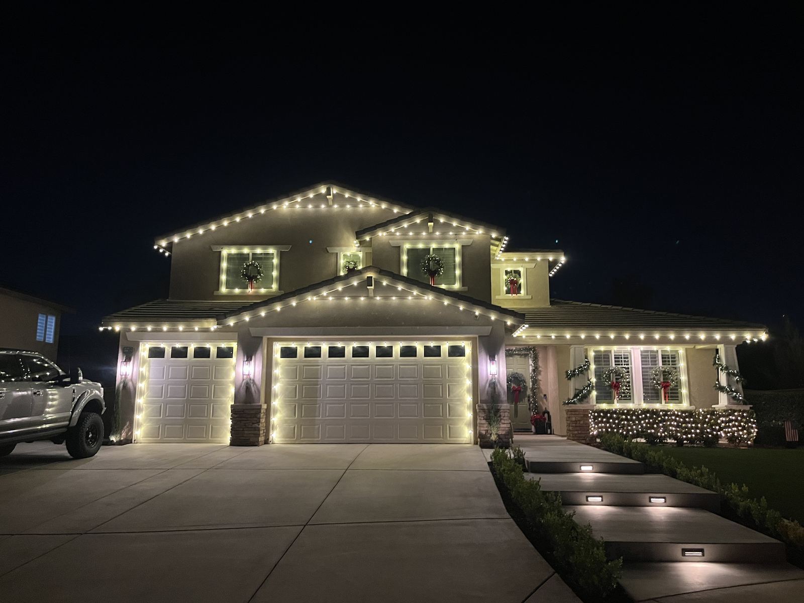 Two story wreaths garage — Christmas light installation in Riverside, CA
