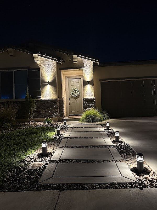 Landscape pathway lighting at entry walk with wall sconces