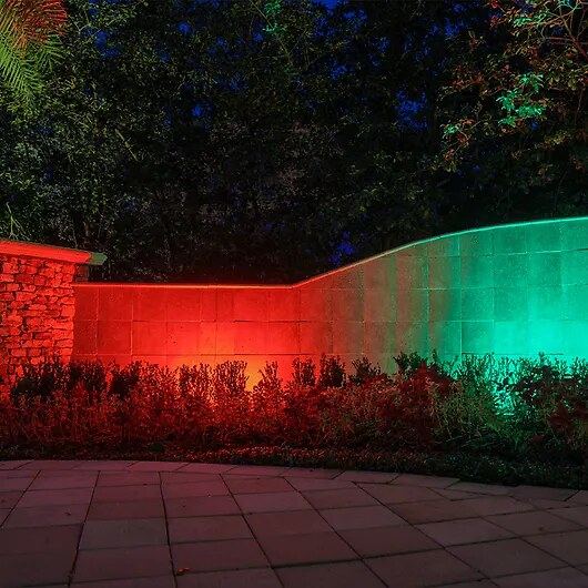 Color wash garden wall red green — landscape lighting install in Riverside, CA