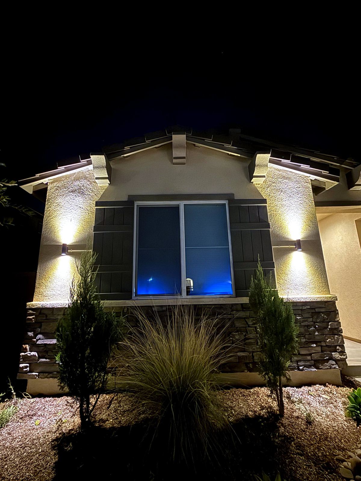 Gable uplighting facade night — landscape lighting install in Riverside, CA