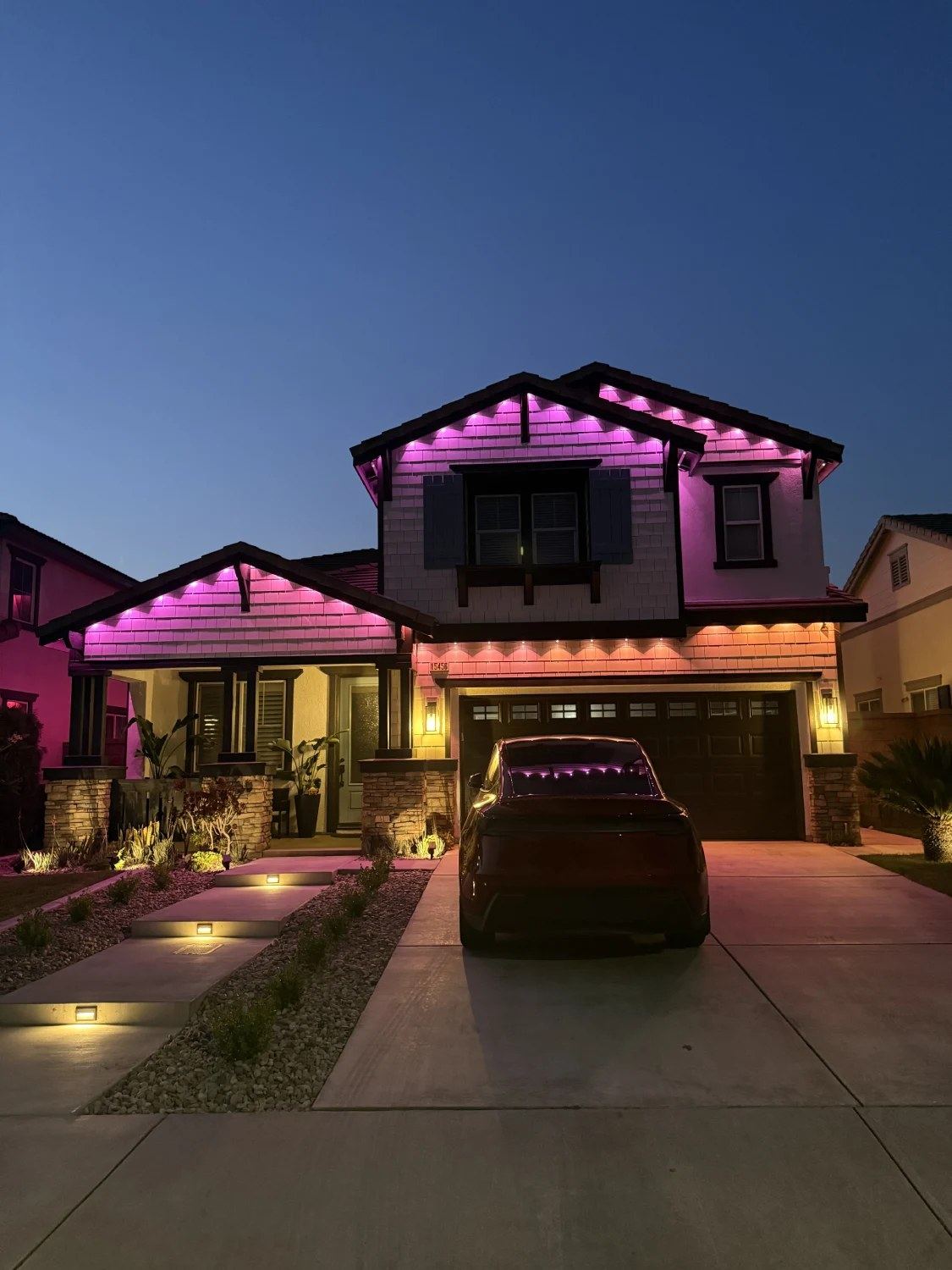 Permanent pink and orange roofline lighting install