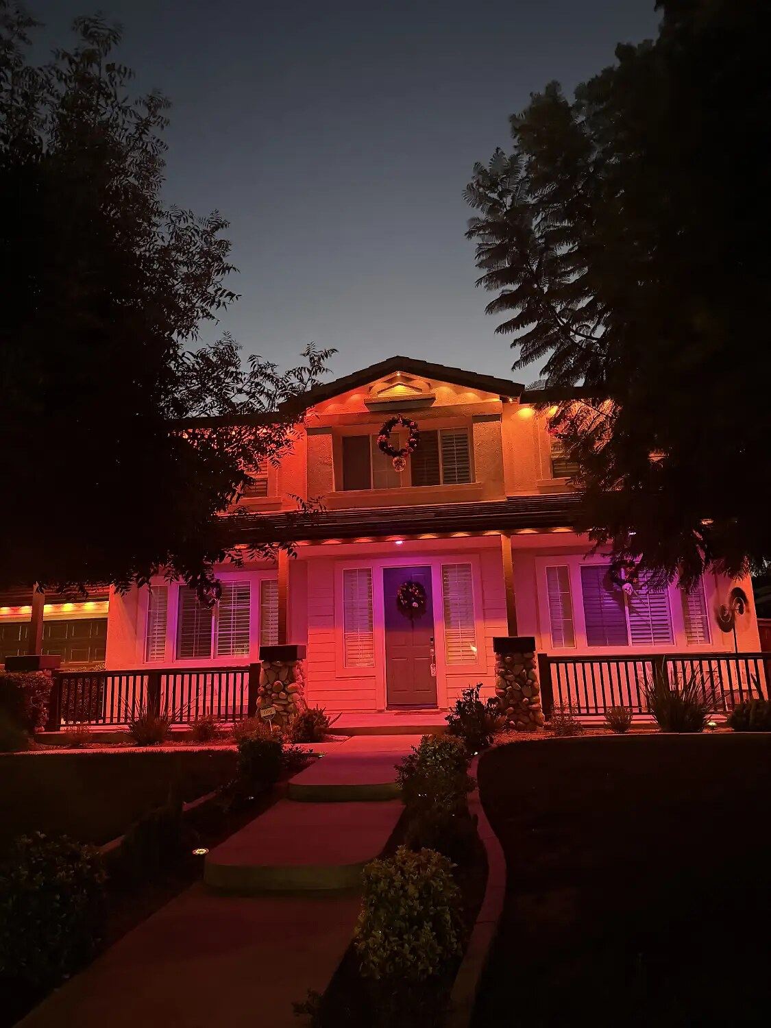 Craftsman red pink porch dusk — permanent LED roofline lighting in Riverside, CA