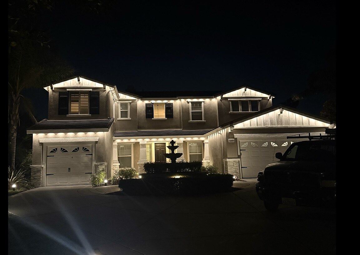 Estate warm white fountain night — permanent LED roofline lighting in Riverside, CA