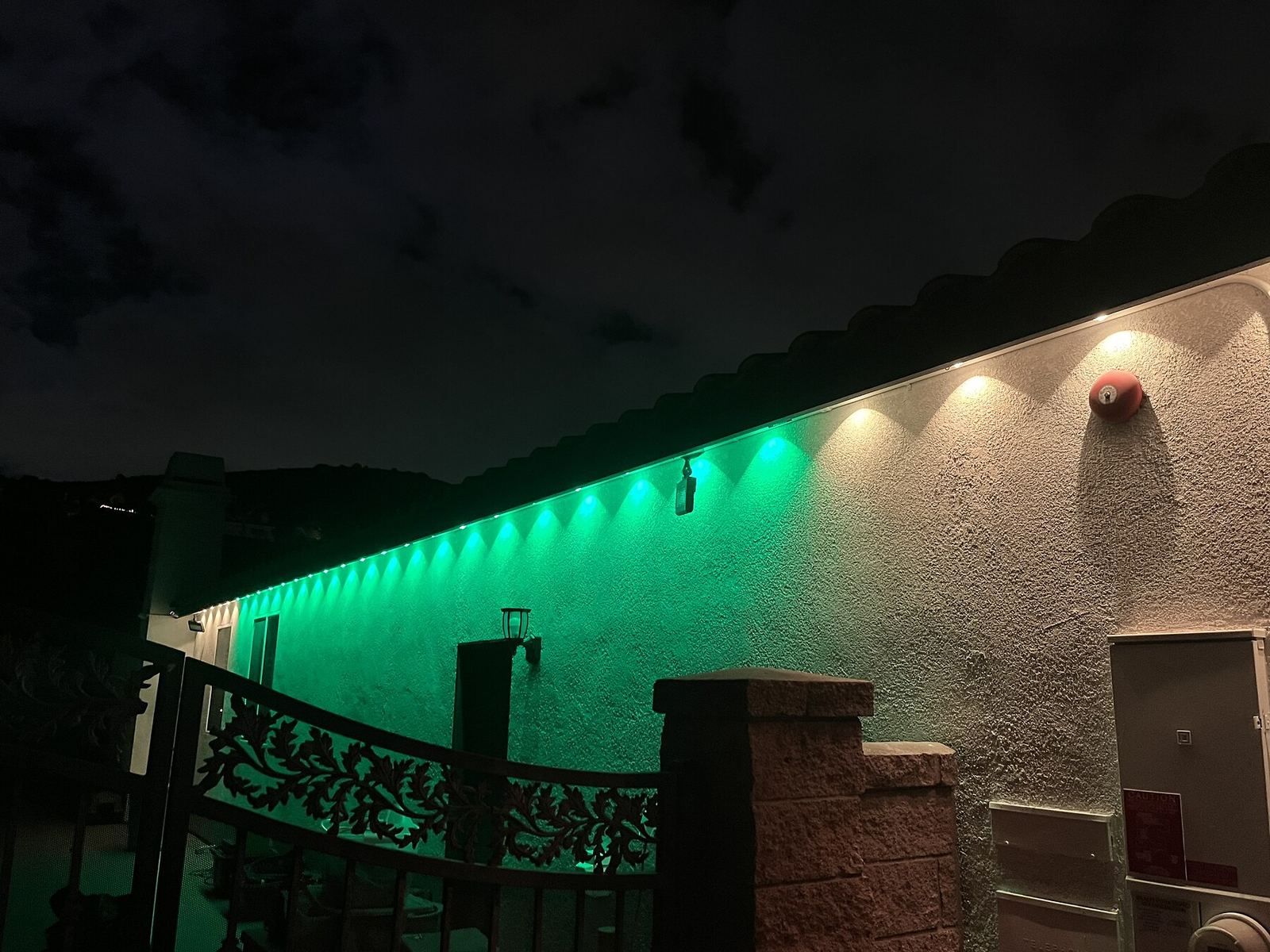 Green roofline closeup night — permanent LED roofline lighting in Riverside, CA