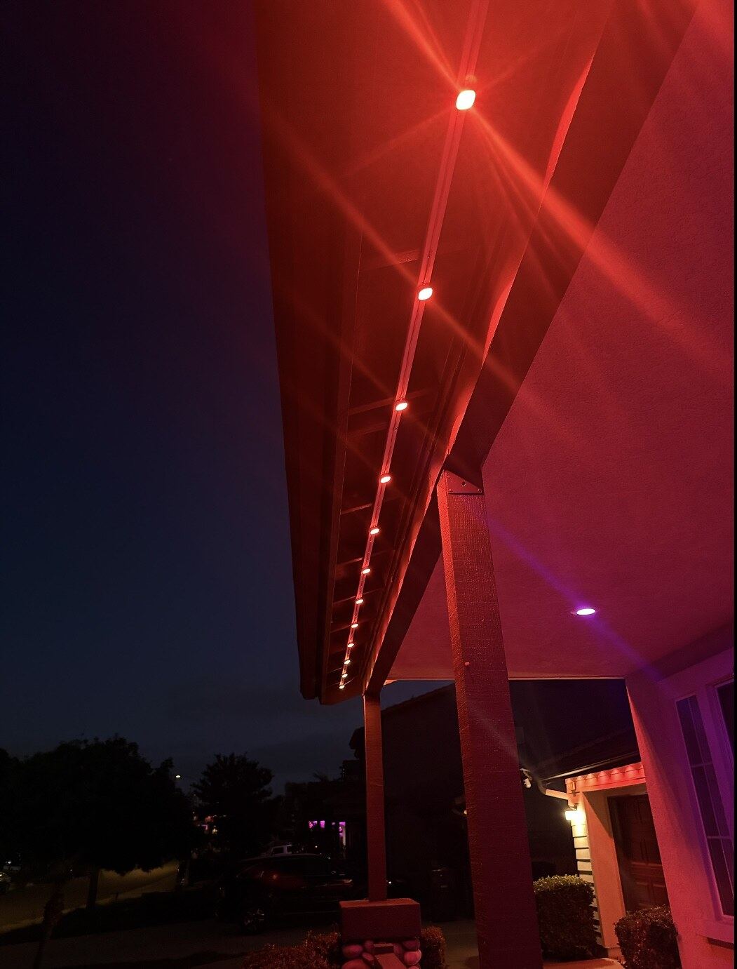 Single story warm white chimney dusk — permanent LED roofline lighting in Riverside, CA