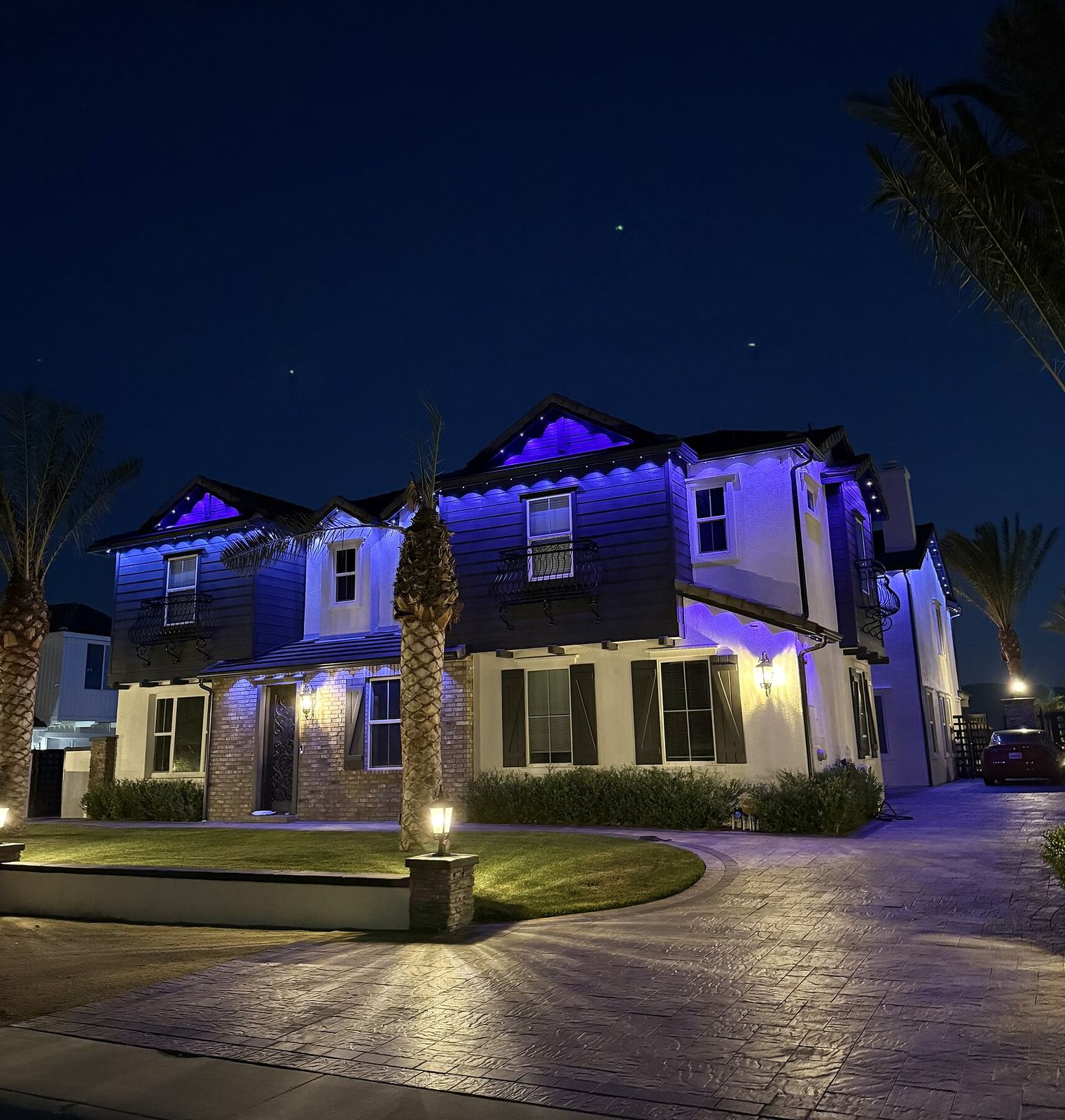 Two story blue dusk circular driveway — permanent LED roofline lighting in Riverside, CA
