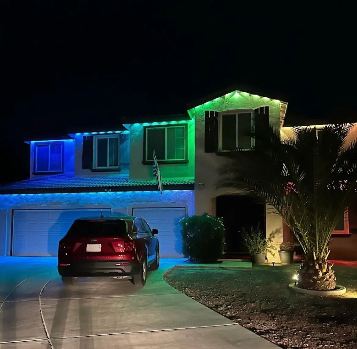 Two story blue green palm car night — permanent LED roofline lighting in Riverside, CA