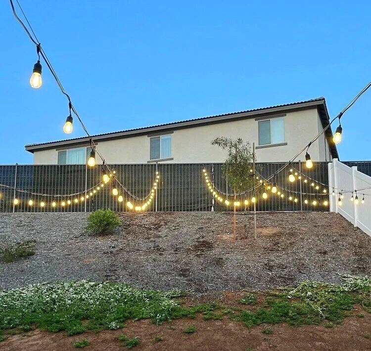 Fence drape dusk — bistro & string lighting install in Riverside, CA
