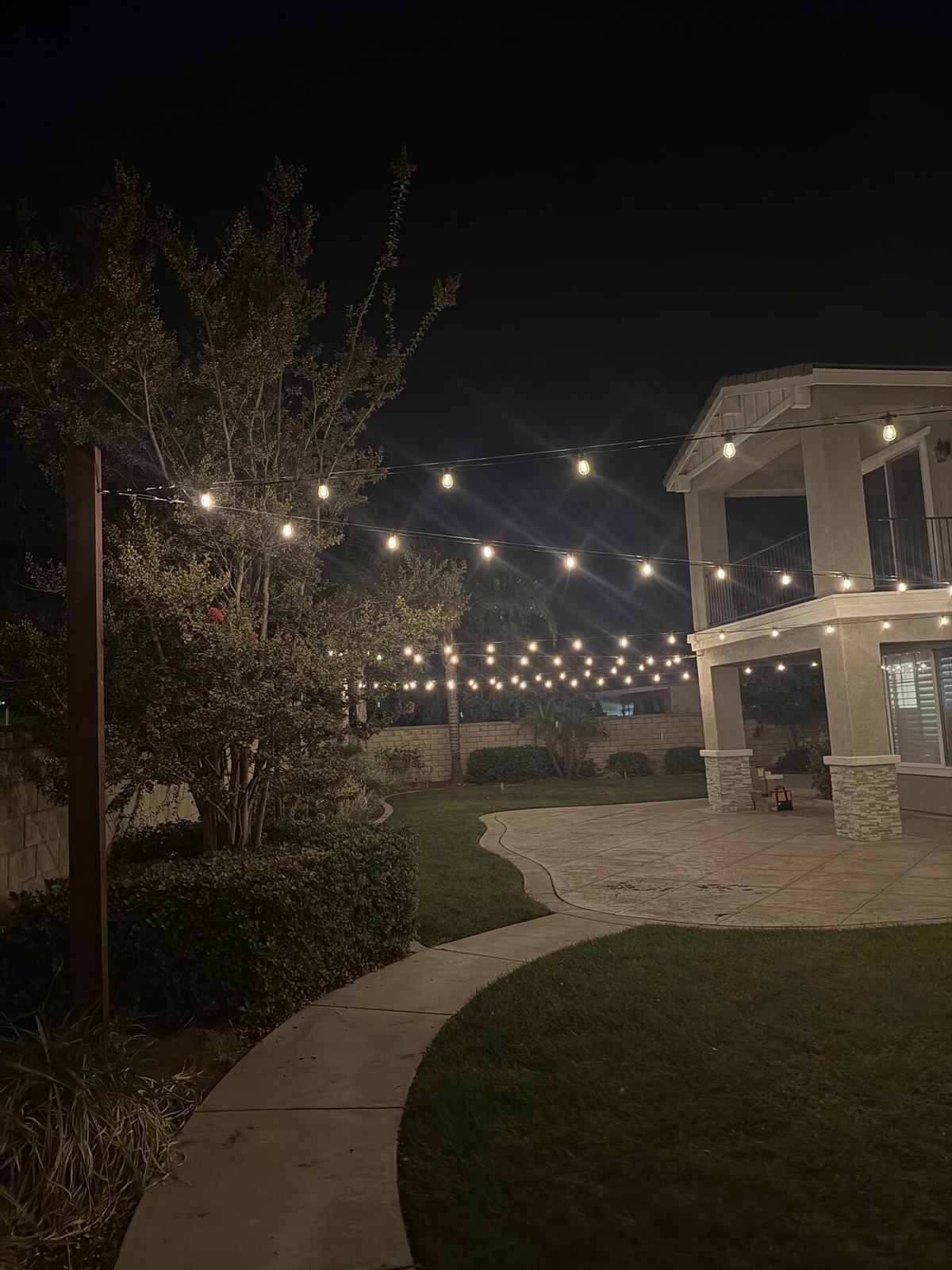 Patio tree house night — bistro & string lighting install in Riverside, CA