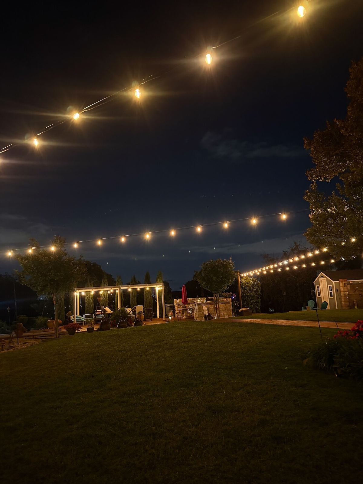 Backyard shed lawn night — bistro & string lighting install in Riverside, CA