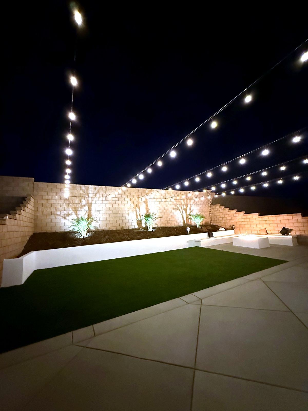 Block wall green uplit patio — bistro & string lighting install in Riverside, CA