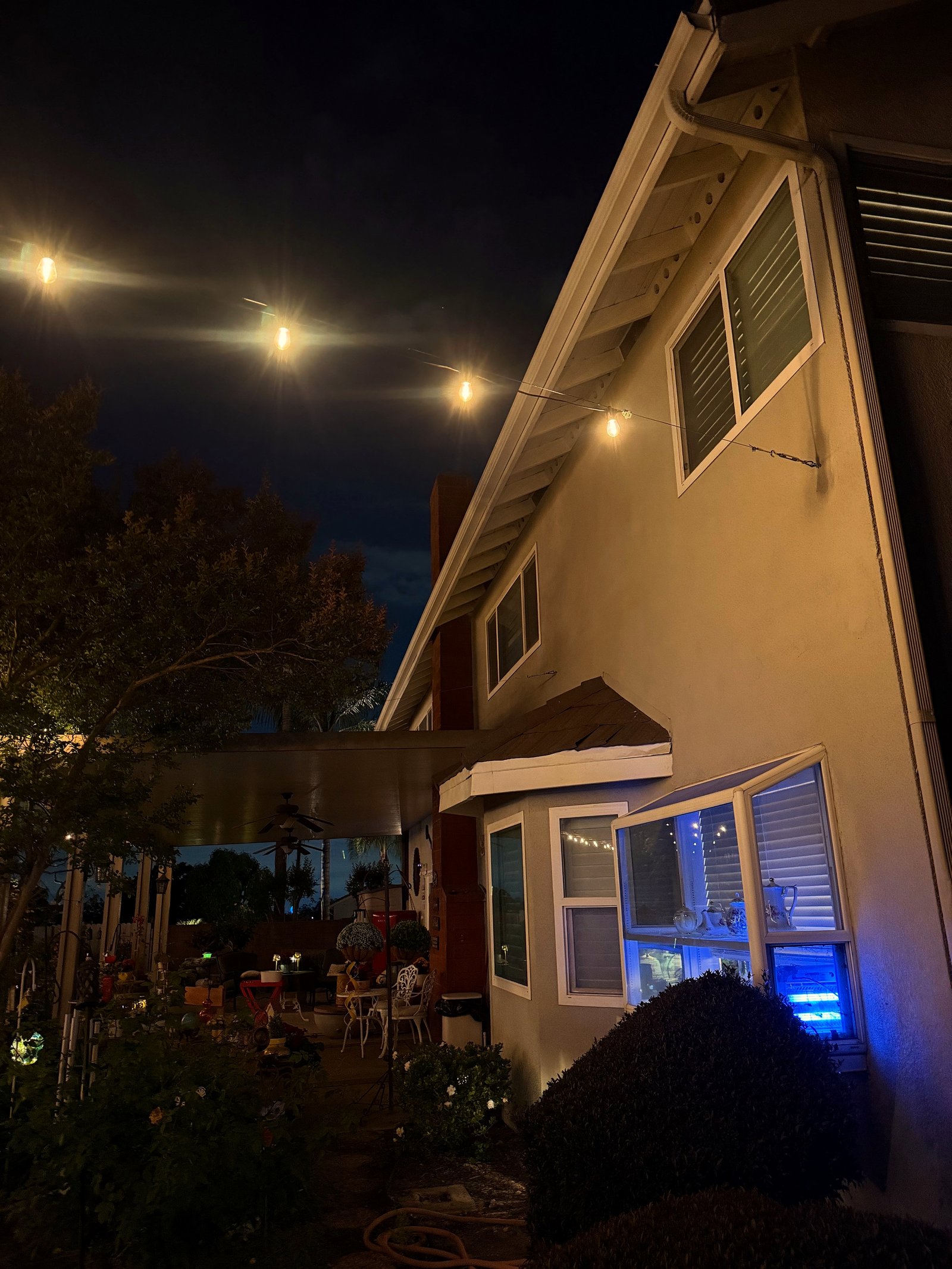 House blue window night — bistro & string lighting install in Riverside, CA