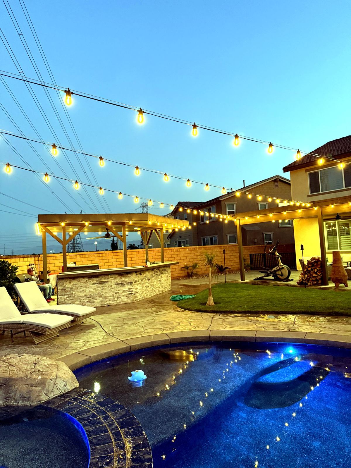 Pool bar lounge dusk — bistro & string lighting install in Riverside, CA